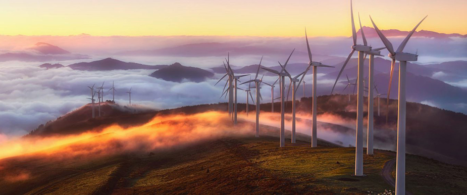 Vindkraftverk på en soluppgångsbelyst bergskedja, illustrerar Renewable Opportunities – I SEK.